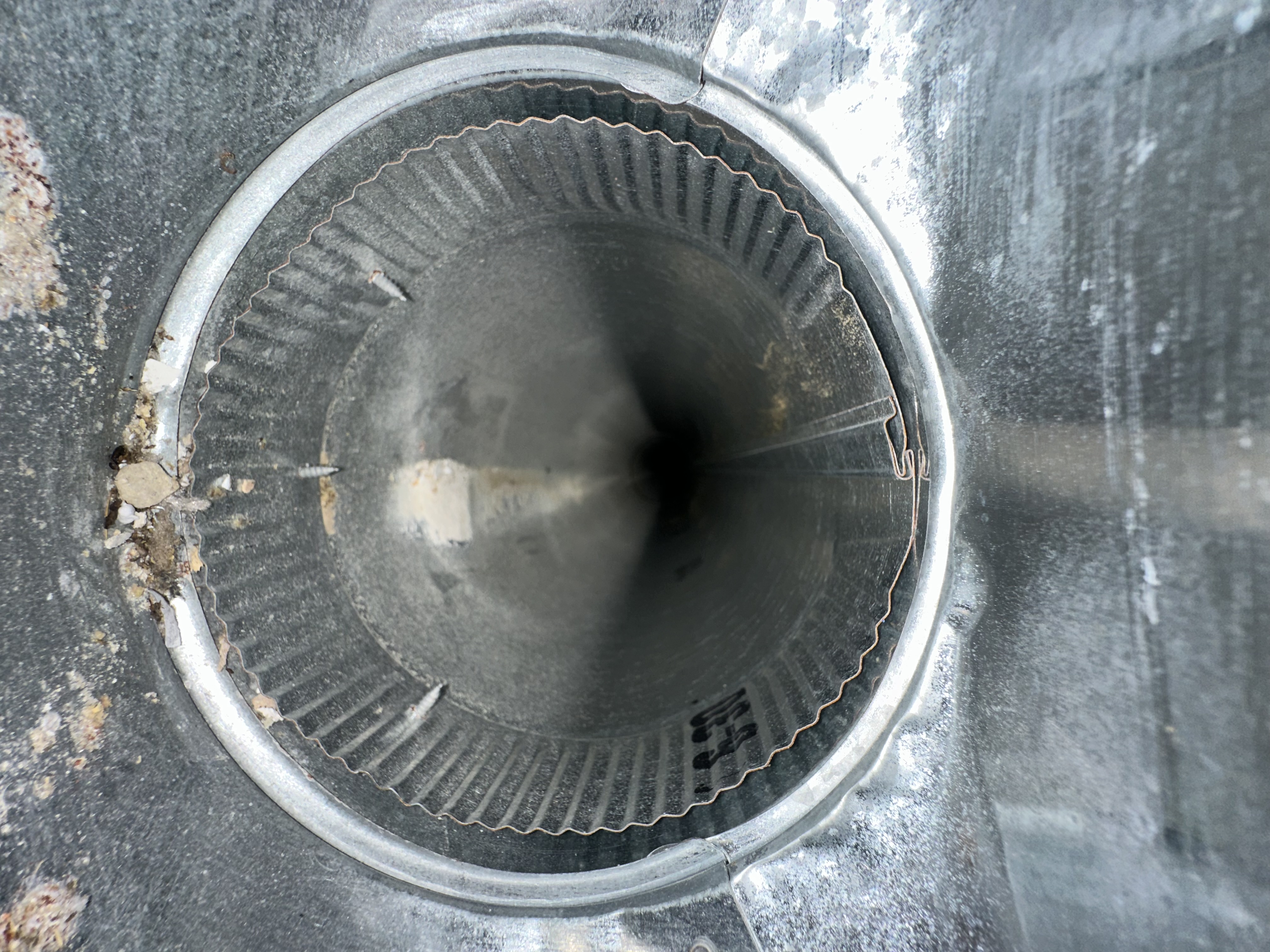 New construction Pickerington home duct showing sawdust and drywall debris from build process — cleaned before homeowner takes possession